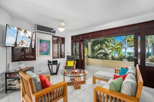 a living room with a couch and a table at Cabarete Palm Beach Condos in Cabarete