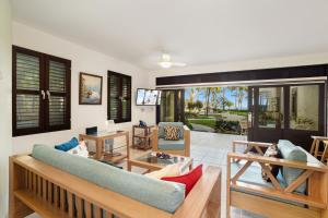 a living room with a couch and a table at Cabarete Palm Beach Condos in Cabarete