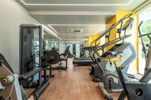 a gym with treadmills and elliptical machines at Point Convenience by Marzani Host in Goiânia