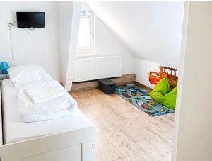 a white room with a bed and a rug at Mikes Fewo in Hohegeiß