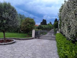 a garden with a gate and a stone walkway at Green Oasis Retreat in Bar +14 photos