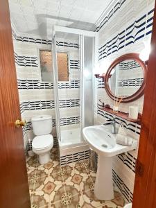 a bathroom with a toilet and a sink at Big vacation apartment BI in Guardamar del Segura +12 photos