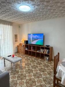 a living room with a tv and a coffee table at Big vacation apartment BI in Guardamar del Segura
