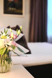 a vase filled with flowers sitting on a table at Usmas muiža in Usma +55 photos