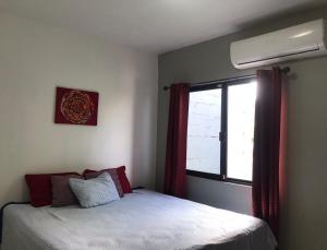 a bedroom with a bed and a window at Estudio #3 a 10 min del malecon in La Paz
