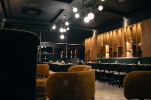 a dining room with chairs and tables and lights at Hotel Sun in Encarnación +44 photos