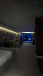 a hotel room with a bed and a living room at نارس البخاري in Buraydah