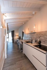 a kitchen with white cabinets and a counter top at Biancaleo Homes in Affi