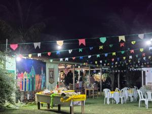a party with a table and chairs and flags at POUSADA SERRA DA CANASTRA in Delfinópolis +95 photos