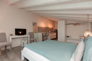 a bedroom with a bed and a living room at Biancaleo Homes in Affi