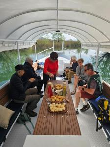 a group of people sitting around a table on a boat at JOCKER in Virpazar +35 photos