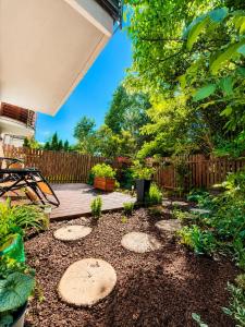 a backyard with a deck and a wooden fence at Zielone Stablowice Wrocław in Wrocław