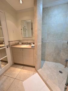a bathroom with a shower and a sink at 117 Sapphire Beach Condo in Christ Church +19 photos