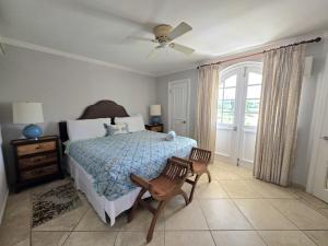 a bedroom with a bed and a ceiling fan at 117 Sapphire Beach Condo in Christ Church