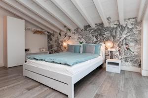 a bedroom with a bed with a wall mural at Biancaleo Homes in Affi +30 photos