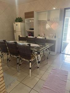 a kitchen with a table and chairs and a refrigerator at Casa do Bosque in Sao Jose do Rio Preto