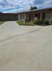 a home with a driveway in front of a house at MERK Guest House in Piet Retief