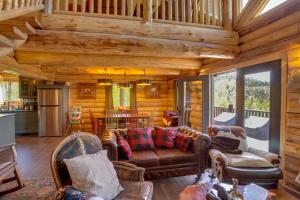 a log cabin living room with couches and a kitchen at Durango Mountain Escape w/ Stunning Views in Durango