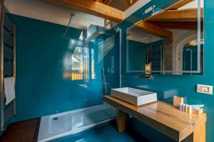 a blue bathroom with a sink and a mirror at Villa Di Natale in Pagani +63 photos