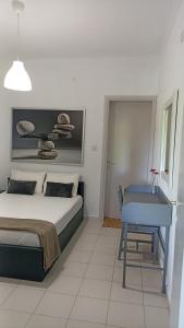 a bedroom with a bed and a table and a desk at Villa Dallas-Beach,Bike & Gym in Vourvourou +64 photos