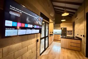 a kitchen with a large screen on the wall at Our Home Granada in Cali