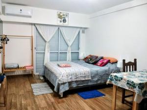 a bedroom with a bed and two tables at Diseñado para vos, a pasos de Bv Oroño con cochera opcional in Rosario +33 photos