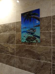 a picture of a boat in the ocean on a wall at Résidence Prestige KGV Appt 304 in Douala