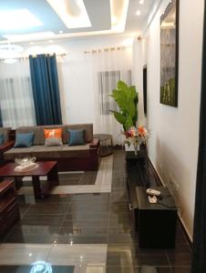 a living room with a couch and a table at Résidence Prestige KGV Appt 304 in Douala