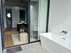 a bathroom with a white tub and a sink at TokioLiving in Armenia +15 photos