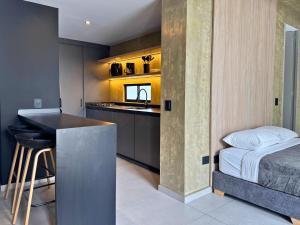 a bedroom with a bed and a kitchen with a counter at TokioLiving in Armenia