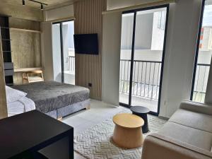 a bedroom with a bed and a couch and a table at TokioLiving in Armenia
