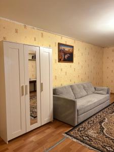 a living room with a couch and a mirror at Marsel Odesa in Odesa