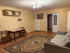 a living room with a table and a couch at Marsel Odesa in Odesa