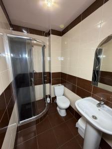 a bathroom with a toilet and a shower and a sink at Sakura Hotel in Zatoka +47 photos