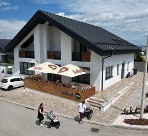a group of people walking in front of a house at Vila Vento in Veľký Slavkov