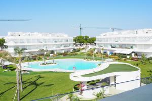 an aerial view of a resort with a swimming pool at Penthouse duplex with jacuzzi, 5 min to beach in Chipiona