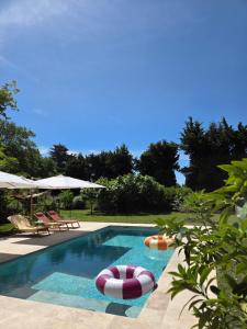 a swimming pool with two inflatables in a yard at CASA ALENTI - Maison d'Hôtes in Beaumes-de-Venise