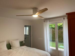 a bedroom with a bed and a ceiling fan at Villa de charme jardin vue sur montagnes rénovation 2026 in Argelès-Gazost