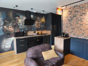 a living room with a couch and a statue of a bear at Escale à Clisson - l'Hippo Loft in Clisson
