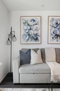 a living room with a couch and two pictures on the wall at Charming 2BR downtown condo with private patio in Toronto +21 photos
