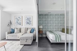 a living room with a couch and a bed at Charming 2BR downtown condo with private patio in Toronto
