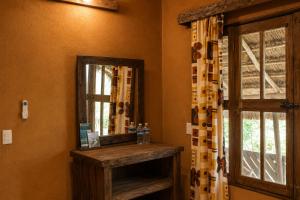 a bathroom with a mirror next to a window at Ixak Cabañas in La Pimienta +51 photos