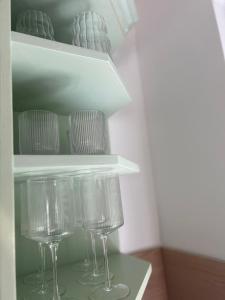 a shelf with wine glasses in a refrigerator at Apartma Prospera - free parking in Maribor +9 photos