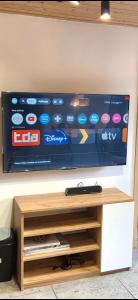 a flat screen tv hanging on a wall at Domek nad jeziorem in Skępe