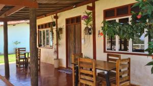 a dining room with a wooden table and chairs at POUSADA SERRA DA CANASTRA in Delfinópolis