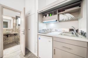 a kitchen with a sink and a counter top at Guesthouse Perdikouli in Aliki