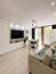 a living room with a couch and a table at Zielone Stablowice Wrocław in Wrocław