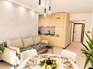 a living room with a couch and a table at Zielone Stablowice Wrocław in Wrocław