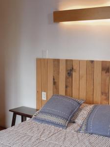 a bedroom with a bed with a wooden headboard at Departamento Yotao in Oaxaca City