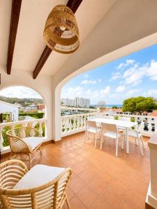 a balcony with a table and chairs and a view at V110B Villa La Pau in Son Bou